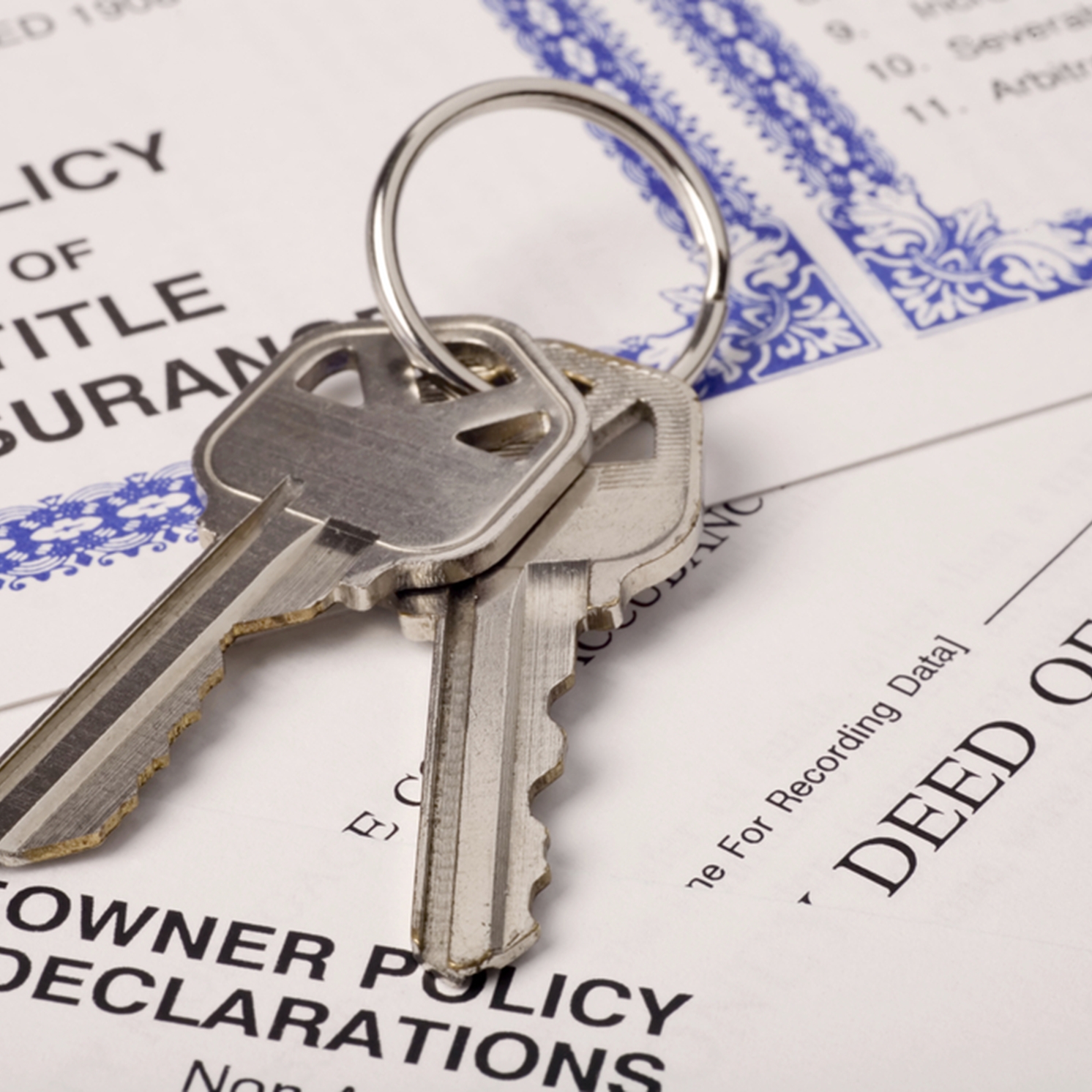 House keys on property deed and documents