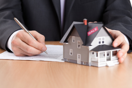 Real estate agent signing house sale contract